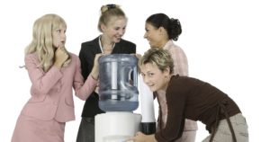 Businesswoman Spying on Water Cooler Conversation